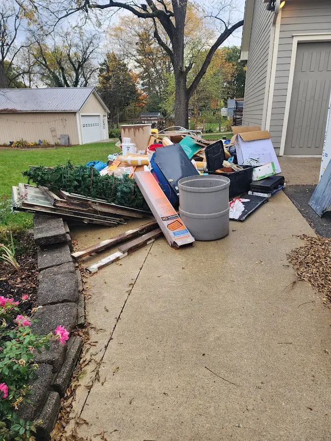 Dumpster being loaded with debris for Roofing Dumpster Rental in Naples Manor